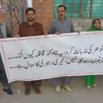 Protestors carrying a banner