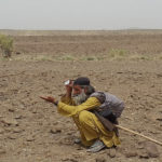 Mama Marri trying local technique to signal the vehicle