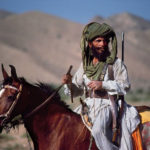 A tribal person riding hourse